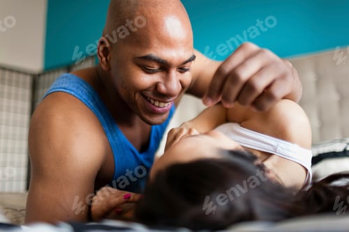 Preview: Mid adult couple relaxing on bed