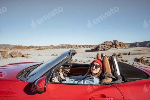 Preview: Woman traveling by cabriolet car on the desert velley