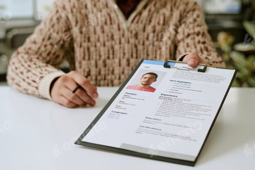 Preview: Young Adult Man Holding Resume during Job Interview Process