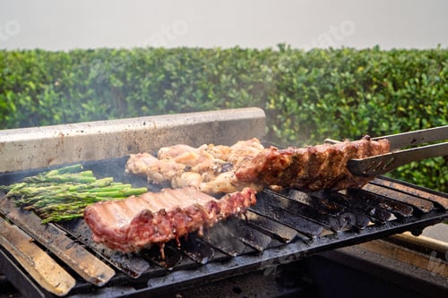Preview: Grilling ribs, chicken wings, and asparagus creating delicious smoke