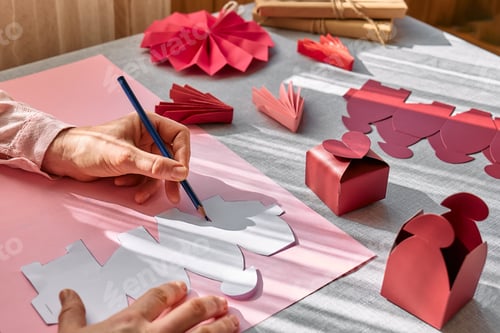 Preview: Woman's hands making handmade heart shaped gift box for Valentines day,birthday,Mothers day,wedding.