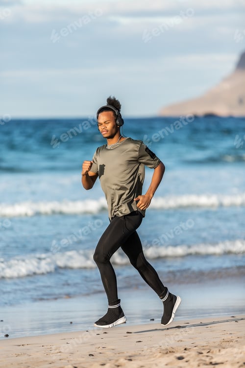 Preview: Black guy in headphones running near sea