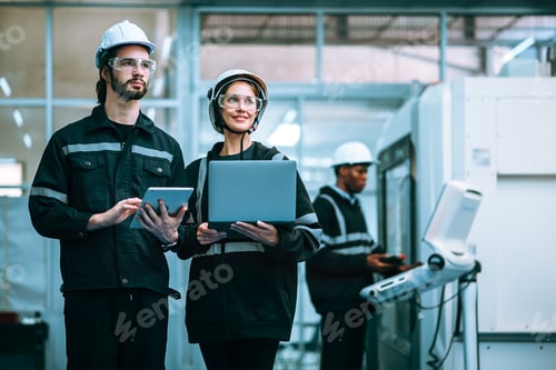 Preview: Robotic engineer male and female using laptop for working in factory