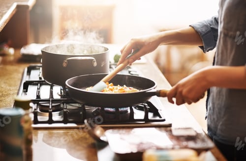 Preview: The start of something delicious. Cropped shot of a young woman preparing a meal at home.