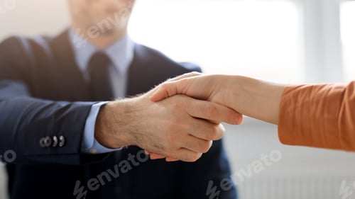 Preview: Business partnership. Male and female entrepreneurs shaking hands, celebrating cooperation agreement