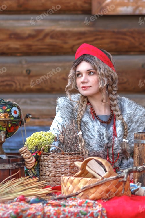 Preview: A girl in traditional Russian clothes and a kokoshnik stands at a table with various national dishes