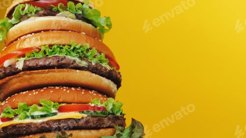 Preview: Giant delicious fresh burgers as cake on yellow background. Cheeseburger