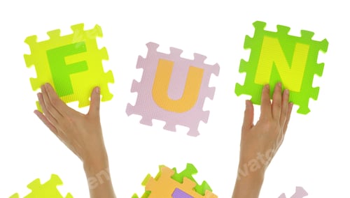 Preview: Hands forming word "Fun" with jigsaw puzzle pieces isolated