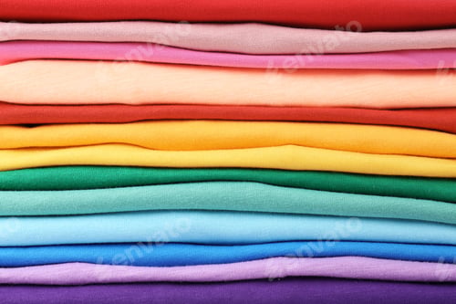 Preview: Stack of colorful t-shirts, close up view