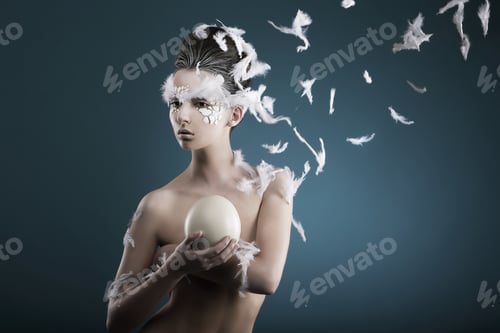Preview: Studio shot of female holding ostrich's egg