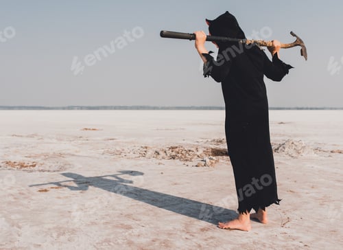 Preview: A boy wearing a scary devil costume and holding a shovel at the salt plains in Oklahoma, USA