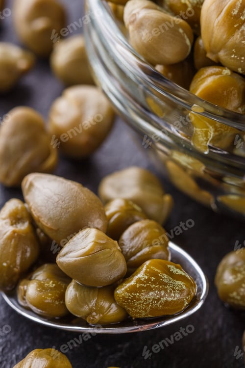Preview: pickled capers on a dark stone background