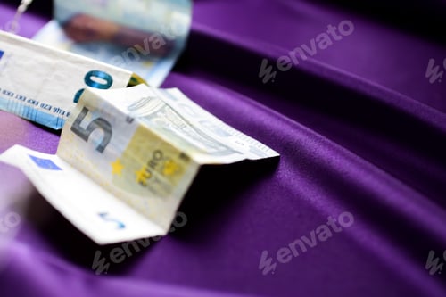 Preview: Cash euro money on purple background