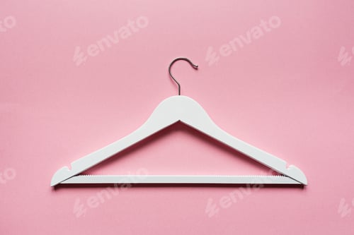 Preview: White wooden hangers on pastel pink background