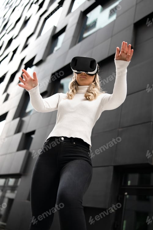 Preview: Woman Gesturing Using Virtual Reality Glasses In Metaverse Business