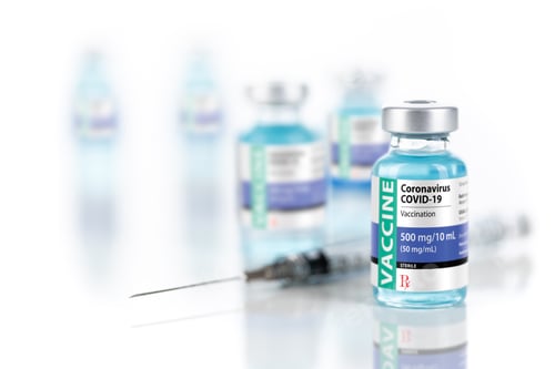 Preview: Coronavirus COVID-19 Vaccine Vials and Syringe On Reflective Surface