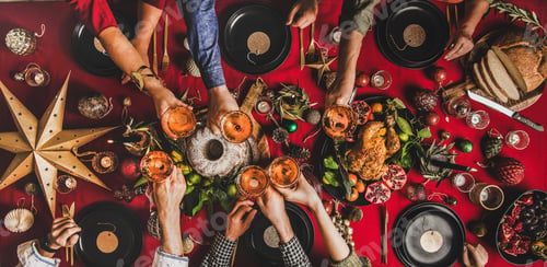 Preview: Flat-lay of family clinking glasses at Christmas table, wide composition