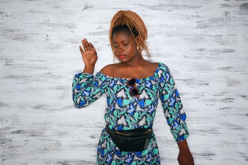 Preview: Woman Poses in a Patterned Dress with Braids