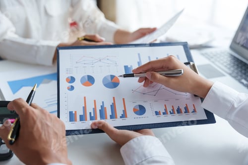 Preview: Business Professionals Analyzing Charts and Graphs in Office