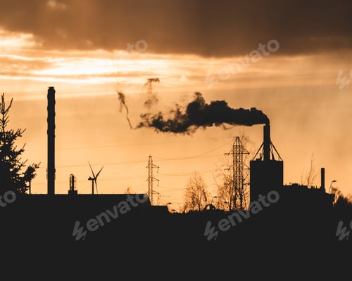 Preview: Silhouette of smoke coming out of a factory pipe during the sunset