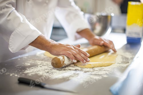 Preview: Chef rolling out dough on table