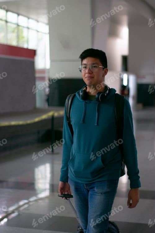 Preview: Man walking with his suitcase and backpack to some place
