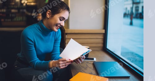 Preview: Cheerful woman reading notes on clipboard
