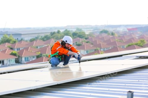 Preview: Workers Installing Solar Panels on warehouse Roof.