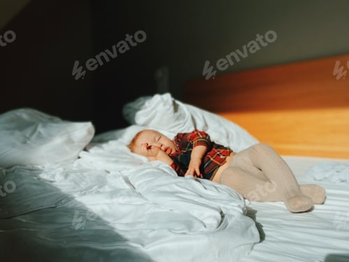 Preview: Restful Toddler Napping Peacefully in Bright Bedroom