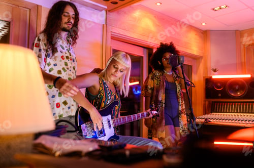 Preview: Diverse performance group making music and recording at music studio.