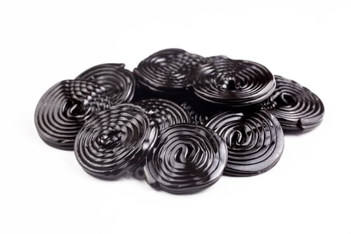 Preview: Licorice candy wheels on white background.