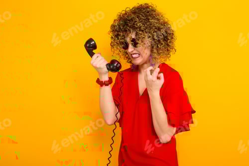 Preview: Attractive woman with short curly hair with phone
