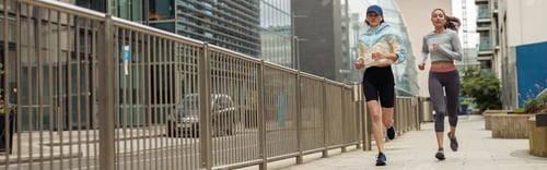 Preview: Two athletic women in sportswear are running around the city. Reaching the goal
