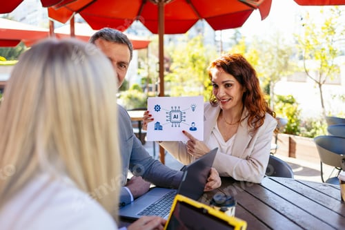 Preview: Business team analyzing artificial intelligence solutions during a meeting at an outdoor cafe