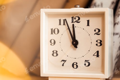 Preview: White vintage clock and pile of books