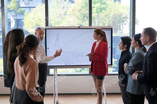 Preview: Business team analyzing growth chart on interactive whiteboard during meeting