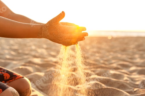 Preview: Little boy playing with sand at sunset