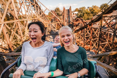 Preview: Young friends riding roller coaster ride