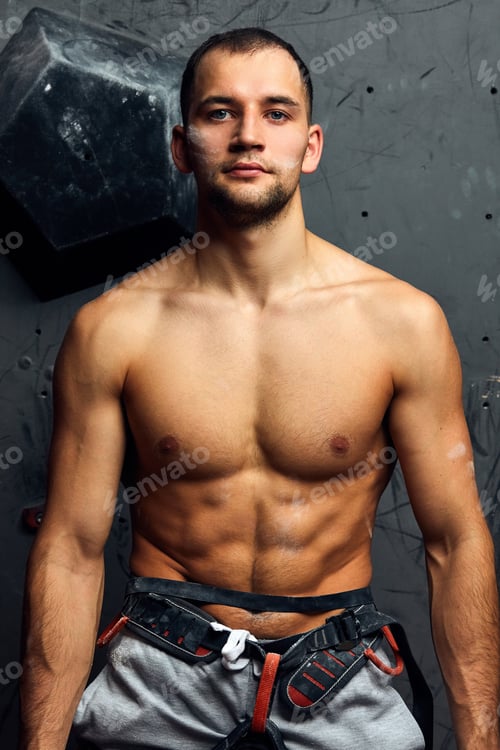 Preview: Closeup portrait of rock climber against artificial wall for climbing