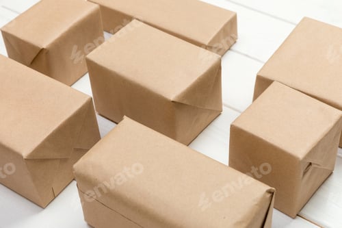 Preview: a lot of cardboard box on white wooden background. top view