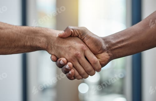 Preview: Closeup shot of two unrecognisable businesspeople shaking hands in an office