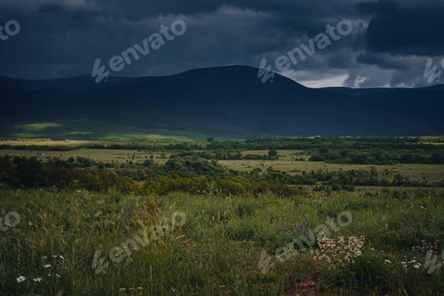 Preview: Picturesque green valley among the mountains before a storm.