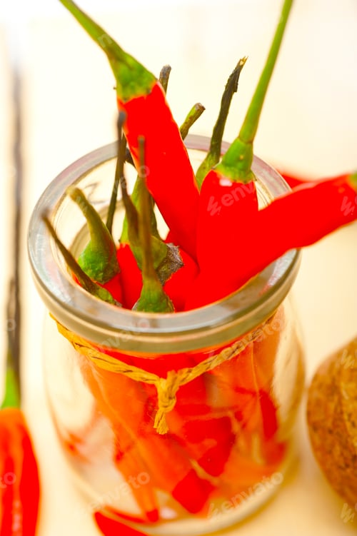 Preview: red chili peppers on a glass jar
