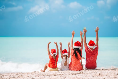 Preview: Happy family with two kids in Santa Hat on summer vacation