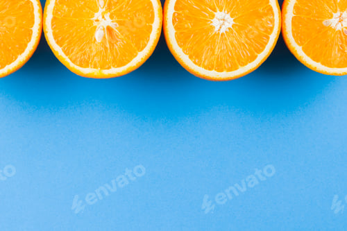 Preview: Cut Halves Of Juicy Orange On Blue Background. Orange Fruit, Citrus Minimal Concept. Creative