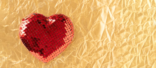 Preview: Red sequin heart on golden crumpled paper