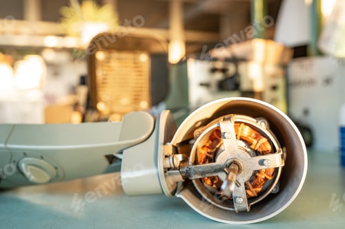 Preview: Close-up of iron motor from home cooling fan lies on a table