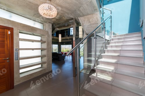 Preview: stairs in interior of modern concrete house, with blue wall and luminaire.