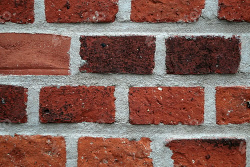 Close-up of red bricks with gray mortar