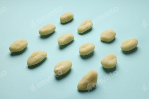 Preview: Raw potato gnocchi on blue background, close up